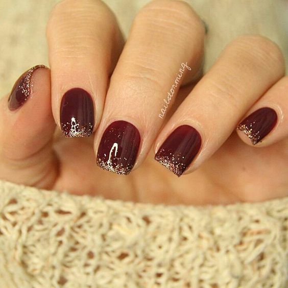 wine nails with golden glitter tips