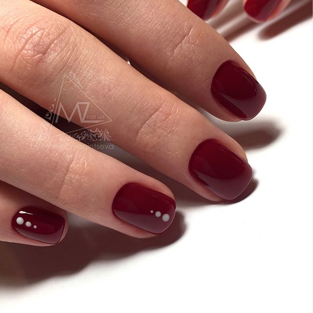 dark red burgundy nails with gold dots