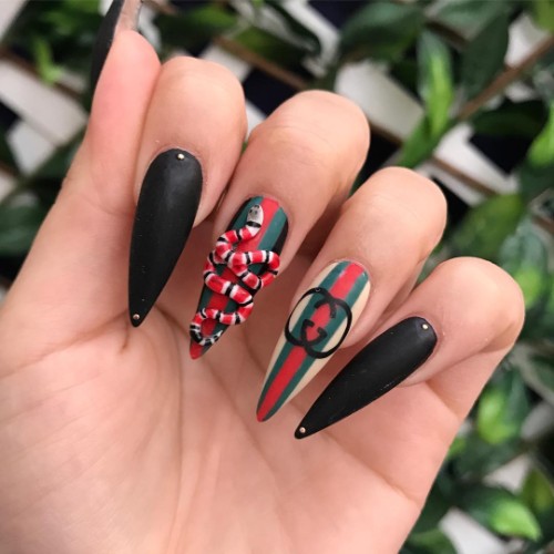 black Gucci nails with a 3D snake