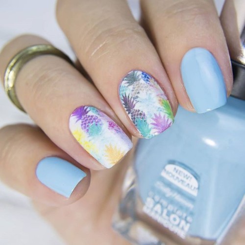 blue and white nails with colorful pineapples