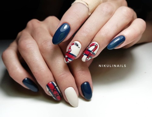 dark blue and white nails with a Gucci red snale