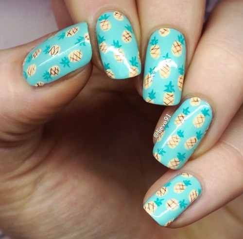 light blue nails with small pineapple pattern