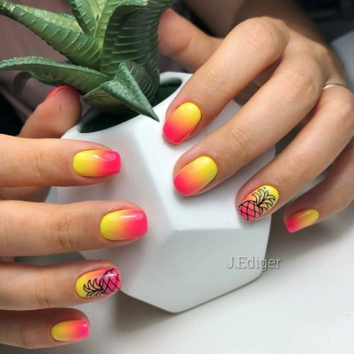 orange and yellow nails with black pineapple silhouette