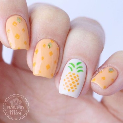 orange nail design with pineapple