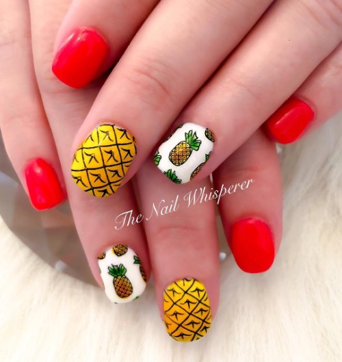 red nail design with pineapples