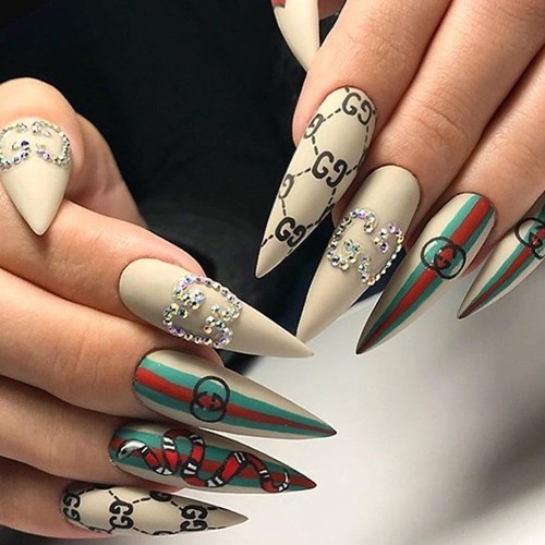 intricate Gucci nail design