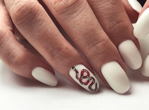 white Gucci nails with a snake