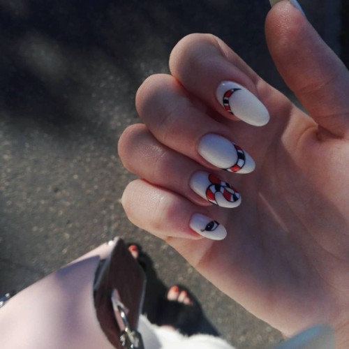 white nail art with a snake