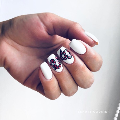 white Gucci manicure with snake