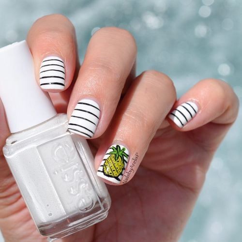 white nail design with black  stripes and pineapple