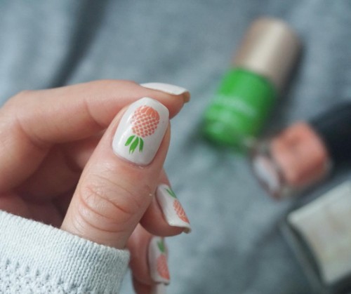 white nails with orange pineapples