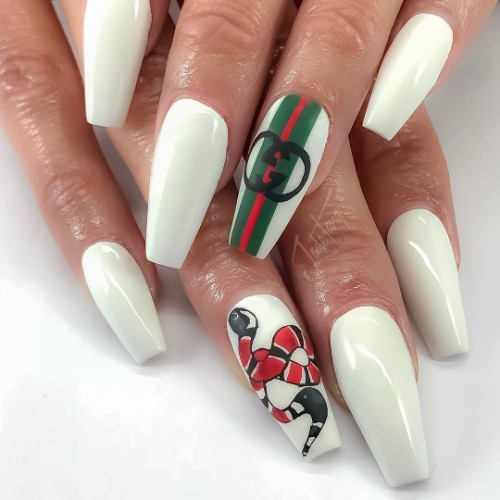 white Gucci manicure with a snake and branded Gucci stripes