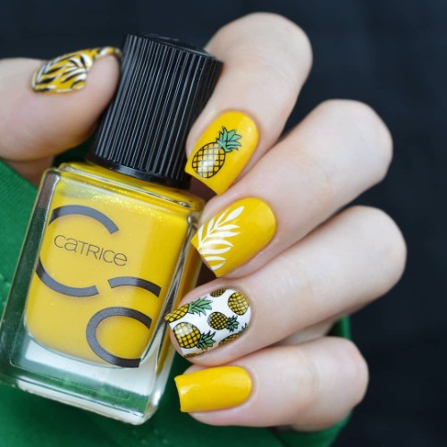 yellow pina colada nail design with pineapples