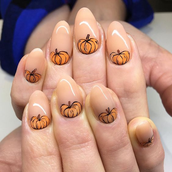 nude-nails-with-orange-pumpkins