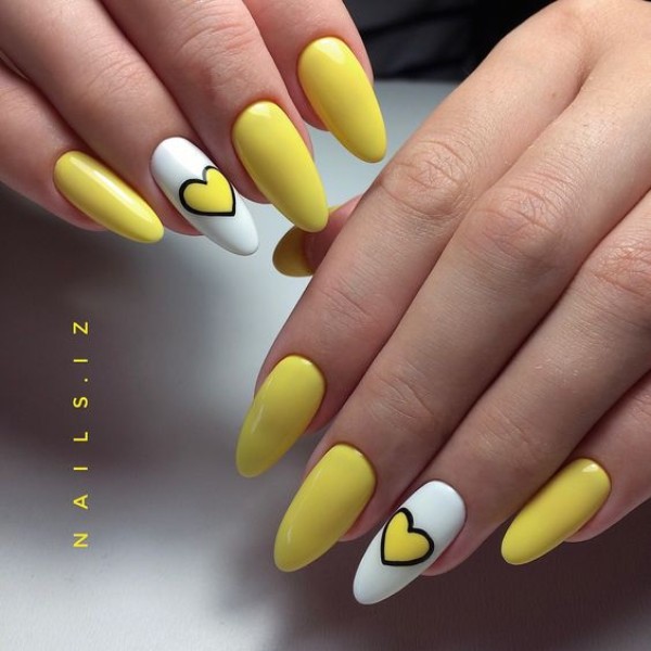 oval almond shaped manicure with white accent nails and yellow hearts