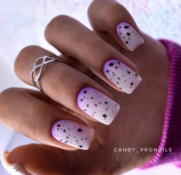 matte nails with purple near the cuticle and black spots
