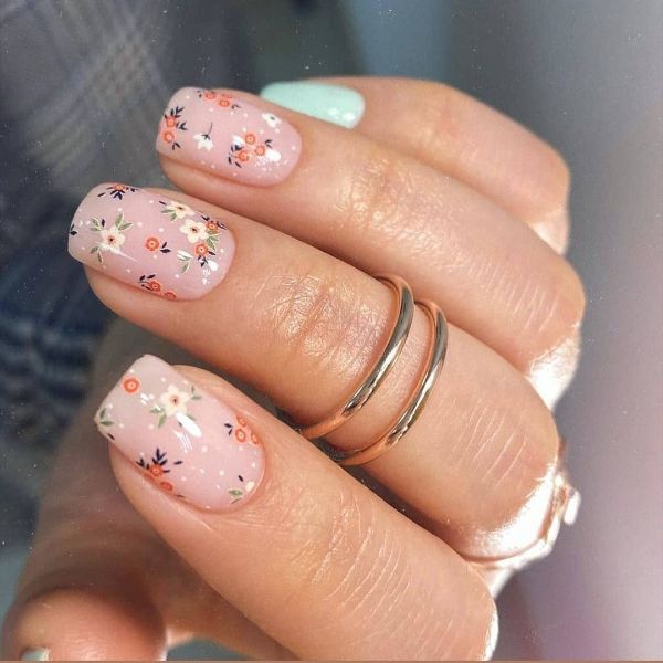 pastel pink and blue nail design with tiny flowers