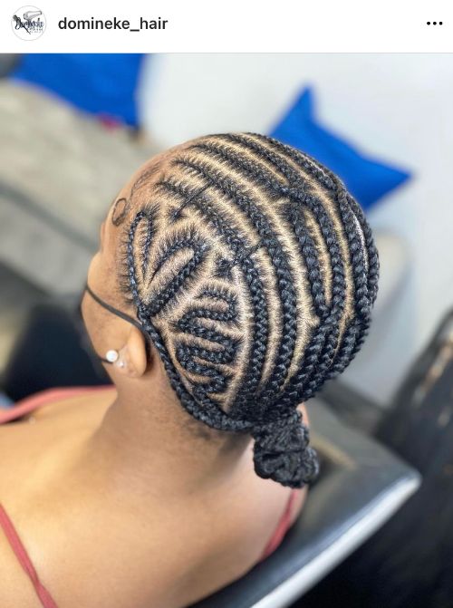 scalp braids with a low bun and a heart on the temple