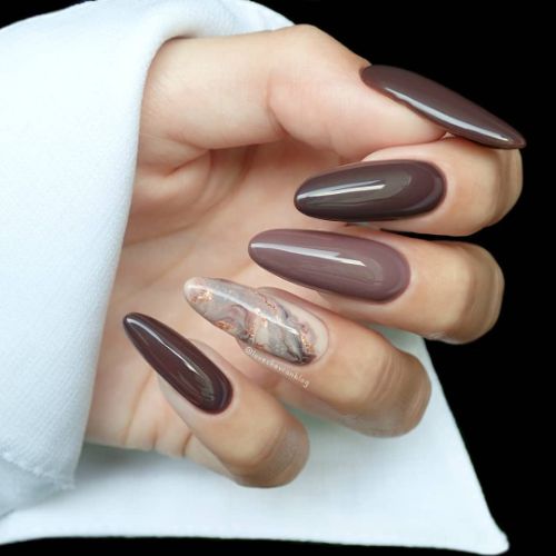 brown nail design with marble accent nail