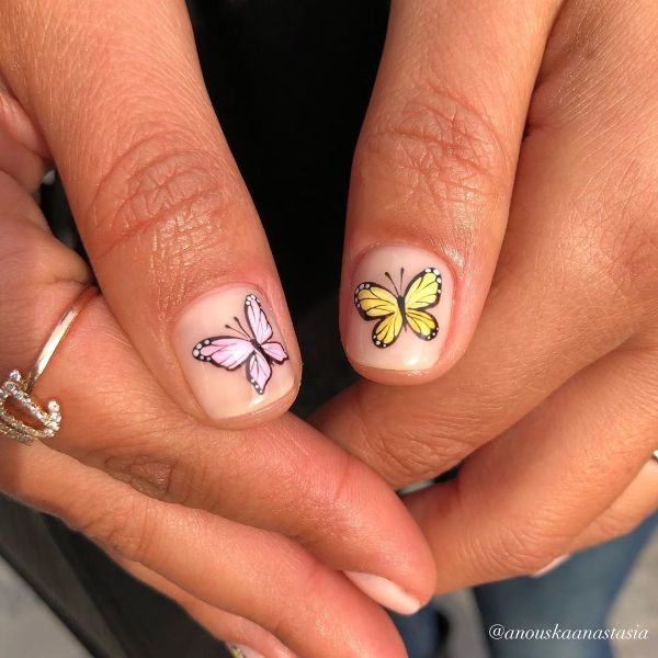 short beige nails with colorful butterflies