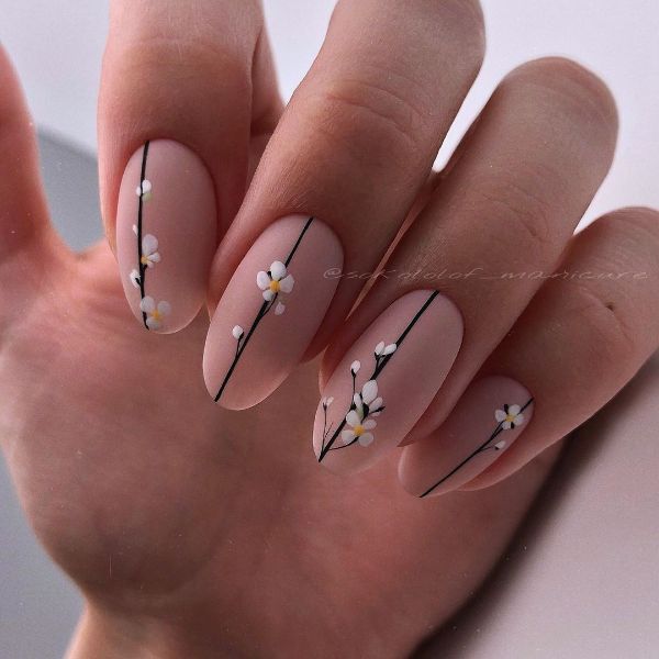 oval matte beige nails with white flowers