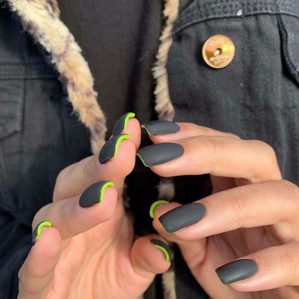very dark gray nails with green underneath