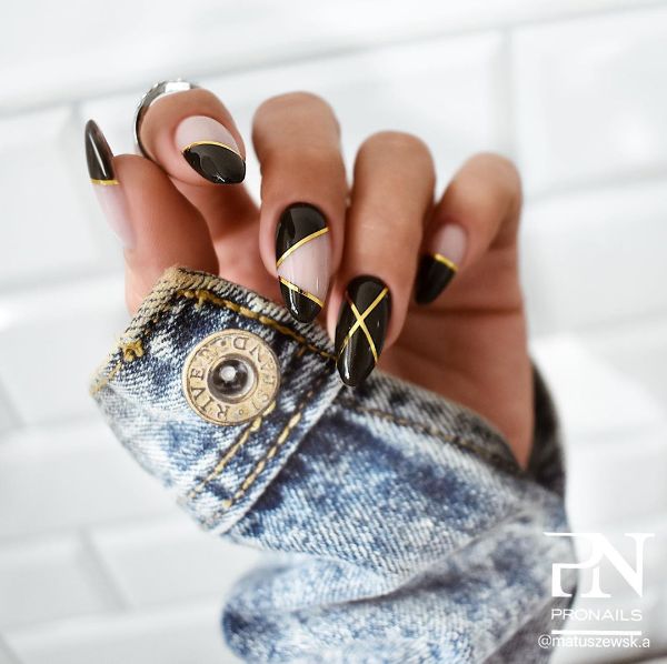 black nails with gold lines made with nail tape