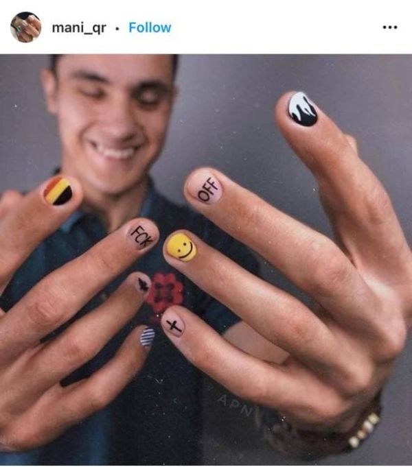 colorful men's nail art with a phrase