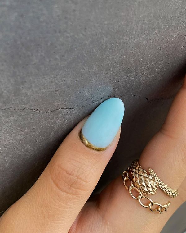 light blue nails with a touch of gold
