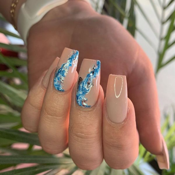 beige nails with blue accent design
