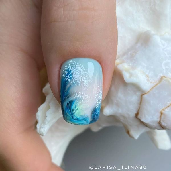 blue nail design with a wave