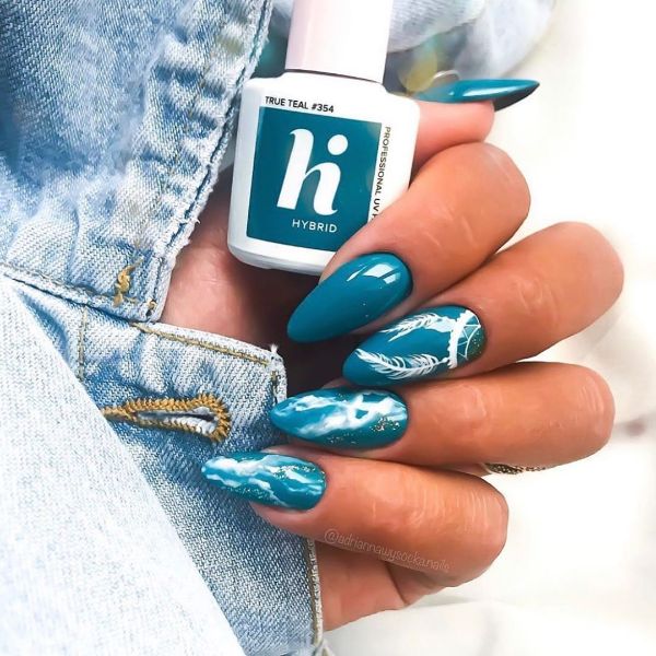 blue nail art with white feathers
