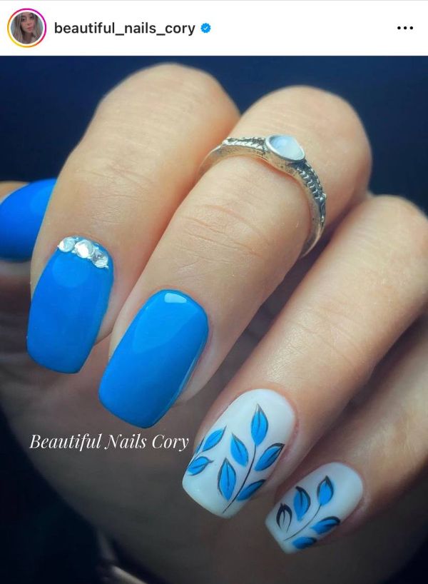 bright blue nail design with leaves