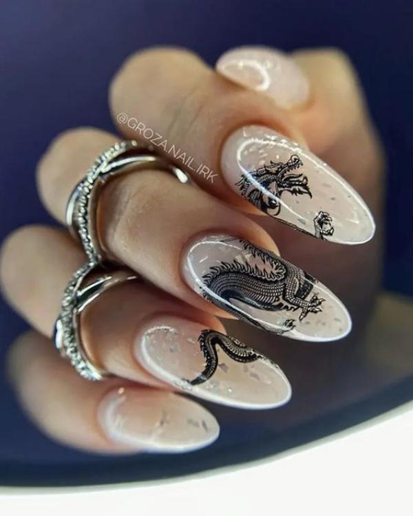 light beige nails with a black dragon
