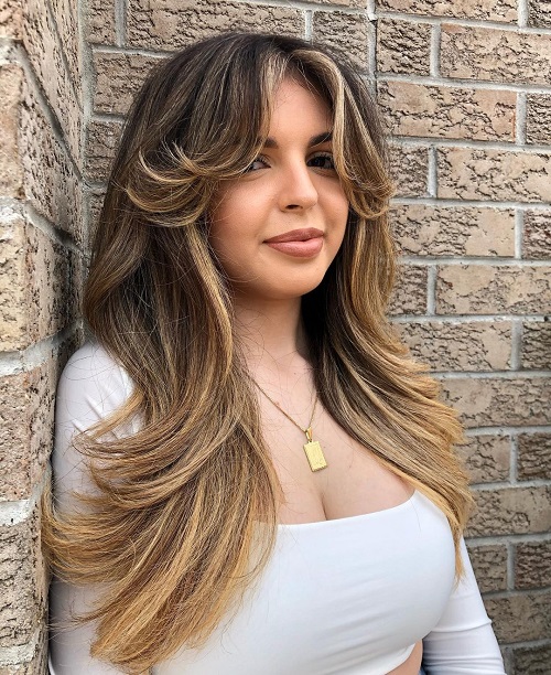 long hairstyle with highlights and curtain bangs