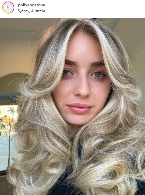 light blonde layered butterfly cut with highlights rom-com hair