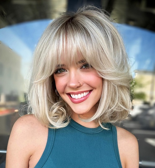 blonde middle-part bob with bangs