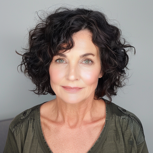 Dark curly hairstyle woman over 50