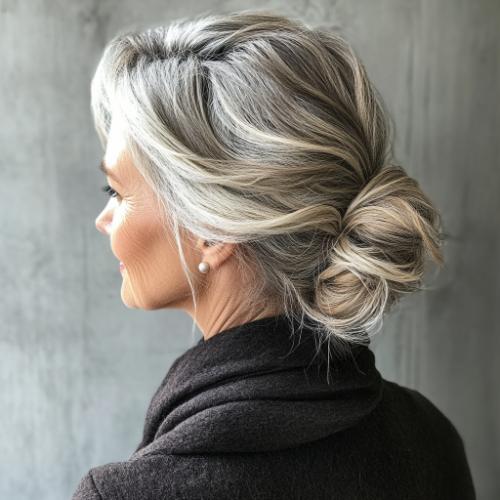 Long hairstyles for women over 60 with a messy low chignon bun