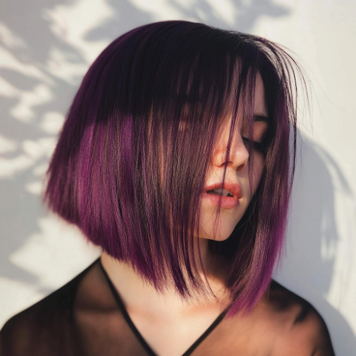 Modern purple bob hairstyle featuring a vibrant and eye-catching color