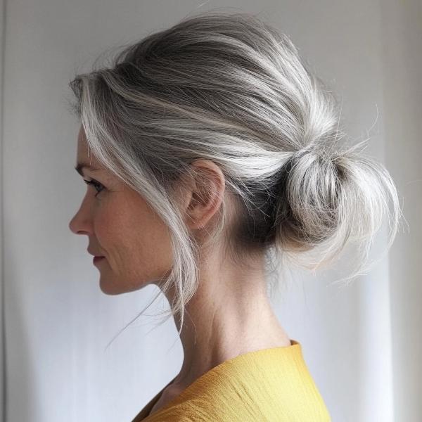 mature woman bun hairstyle for casual wear messy styling