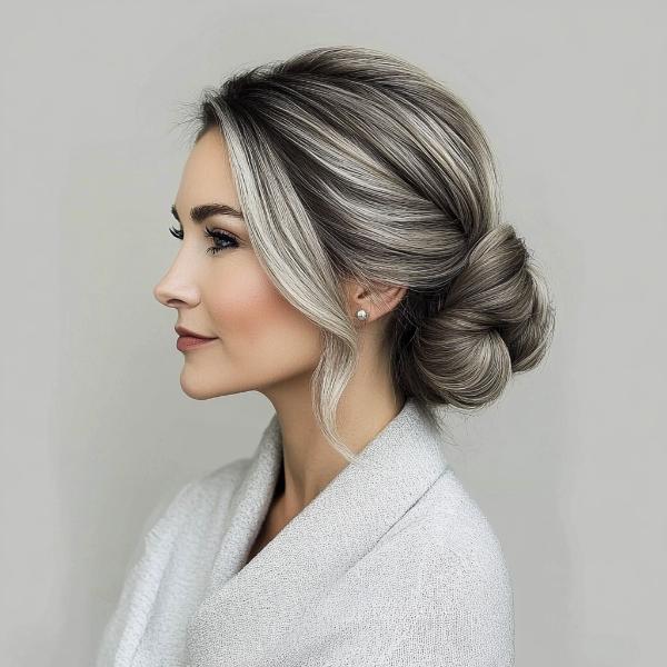 older woman low salt-and-pepper bun chignon