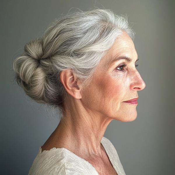 older woman with bun hair and no bangs