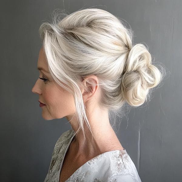 older lady special occasion bun with twists and tendril bangs