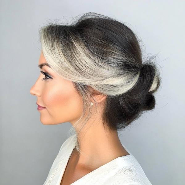 senior woman brown hair with silver front strands bun hair style